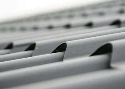 Detailed close-up of grey metal roof sheets showcasing texture and design.